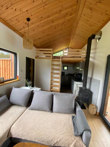 a living room with a couch and a stove at Drewniana ostoja in Jelonek