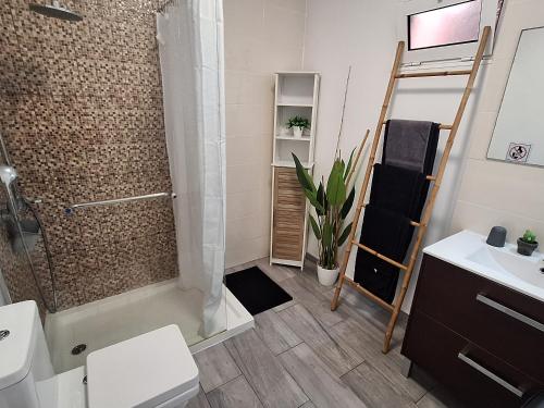 a bathroom with a shower and a toilet and a sink at Funchal House in Funchal