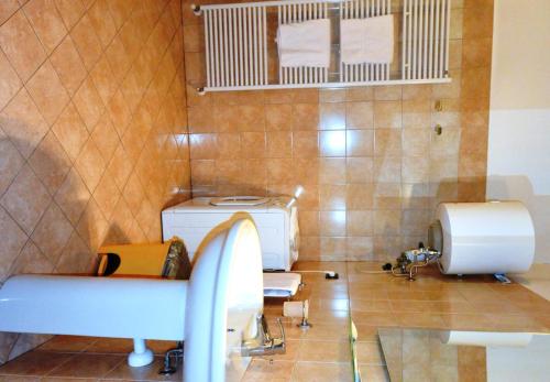 a bathroom with a sink and a washing machine at Residence Alcorso in Mantova