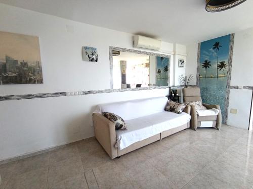 a living room with a couch and a window at Benalmádena Nice Sea Views ! in Benalmádena