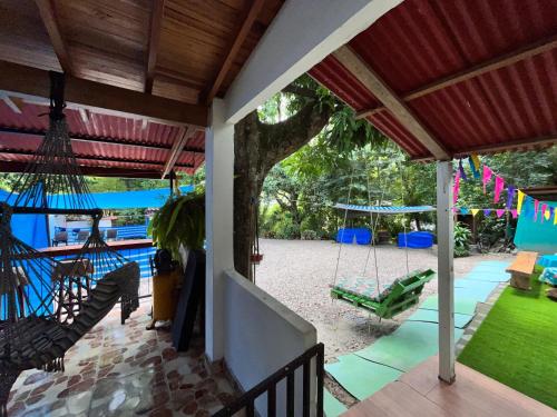 an outdoor patio with swings and a yard at Villa Mercedes in La Dorada
