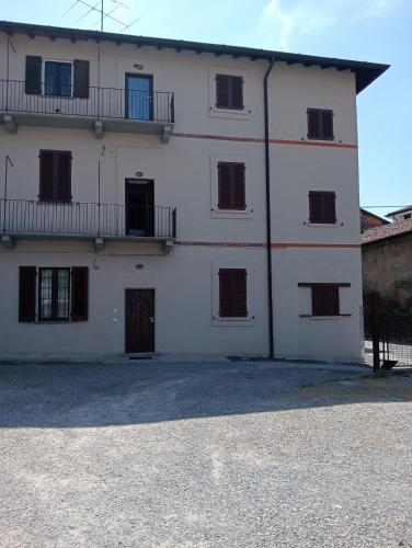 a large white building with windows and a balcony at Vi & Vi relax by the lake in Montorfano