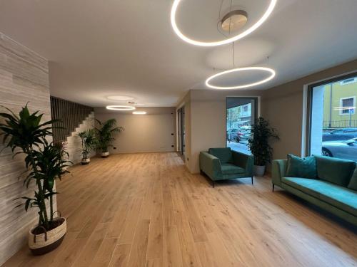 a living room with a couch and chairs in a building at YUGOGO PETRARCA 1 - Trilocale con balcone in Trento