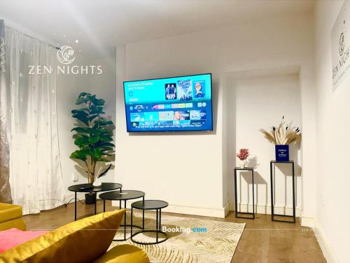 a living room with a tv on a wall at Last-minute Specials l Elegant House near City Center Sleeps 8 with Free Parking l Near DeMontfort Uni l By Zen Nights Short Lets & Serviced Accommodations in Leicester