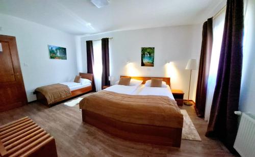 a hotel room with two beds in a room at B&B Plitvice Lakes Villa Mija in Plitvica selo