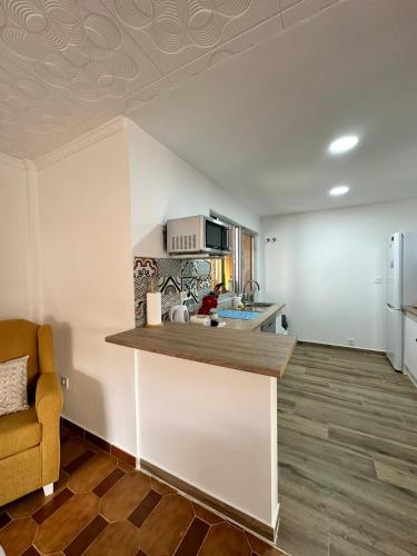 a kitchen with a counter top in a room at Can Guzmu in Cijuela