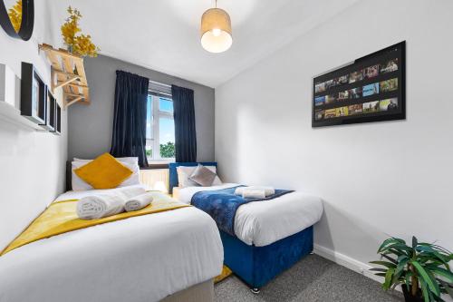 a bedroom with two beds and a window at South Stays 3 in London