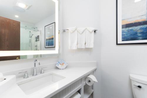a white bathroom with a sink and a toilet at Aspinquid Resort in Ogunquit