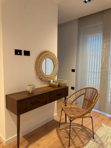 a dressing table with a chair and a mirror at Villa Hana - San Pietro in Fushë-Draç