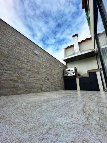 a building with a garage with a brick wall at Curiti Luxury House in Curití