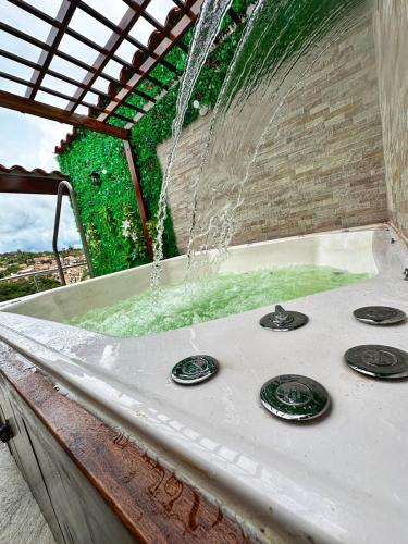 a bath tub with a water fountain at Curiti Luxury House in Curití