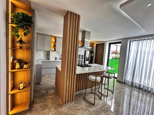 a kitchen with a island in the middle of a room at Curiti Luxury House in Curití