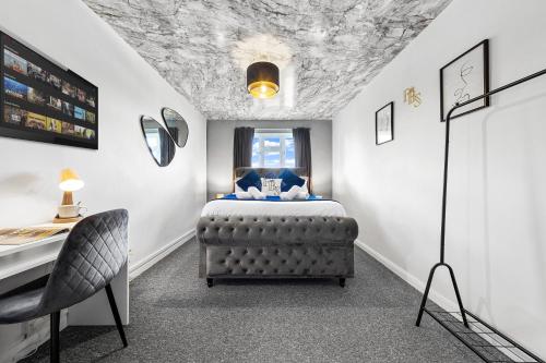 a bedroom with a bed and a table and a chair at South Stays 4 in London