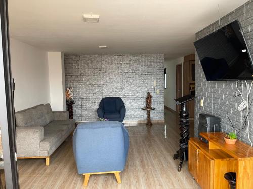 a living room with a couch and a tv at Departamento Medellín bello in Bello