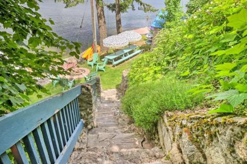 a stairway leading up to a balcony with a view of the water at Huvila Haven Lake Front Home with Dock and Hot Tub in Newman Lake