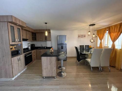 a kitchen and dining room with a table and chairs at Departamento Medellín bello in Bello