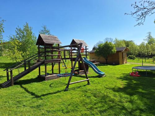 a park with a playground with a slide and a slideintend at Domek SZAŁAS z jacuzzi, blisko Świeradów zdrój i zamek Czocha in Mirsk