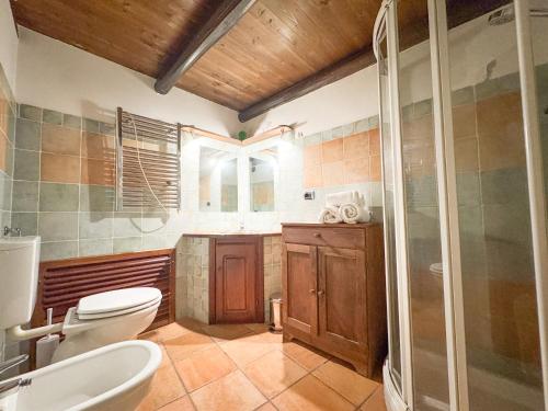 a bathroom with a toilet and a sink and a shower at Kalma Arched Loft - Unique Brick Vault in City Heart in Cagliari