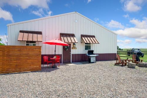 a barn with a table and a red umbrella at Llama-Stay at Spooky Tooth Ranch - Mtn Views! in Loveland