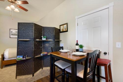 a dining room with a table and chairs and a white door at Llama-Stay at Spooky Tooth Ranch - Mtn Views! in Loveland