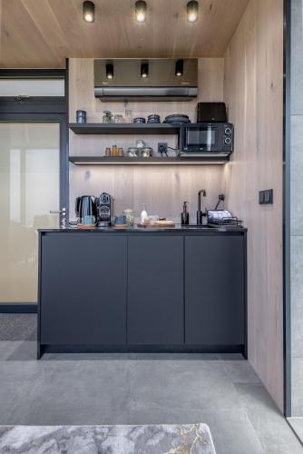 a kitchen with a black counter in a room at The View At Lahill Craig - Duncan in Leven-Fife