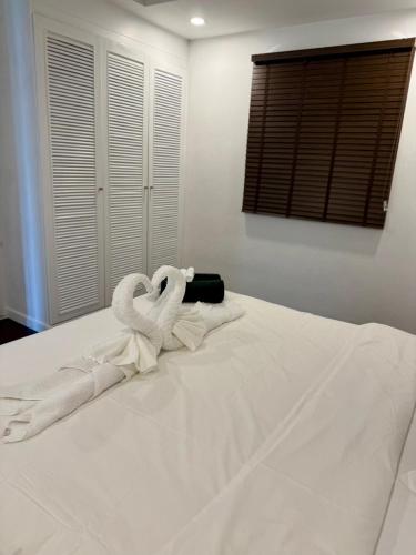 two towel swans sitting on top of a bed at privat com beach villa 5 bedroom in Koh Samui