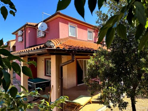 a red house with a roof at Villa Tamaris hidden gem near beach in Jadrija