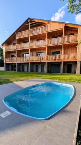 a large blue pool in front of a building at Andrea 's 4 seasons in Albrechtice v Jizerských horách