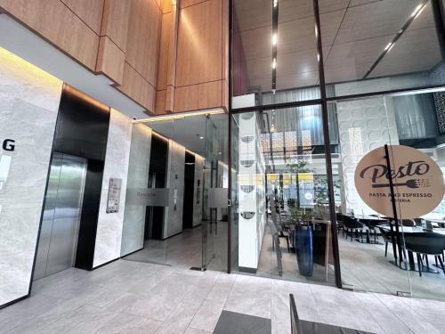 a lobby of a building with glass doors and a restaurant at BTS onnut loft quiet room Netflix Rooftop bar in Bangkok