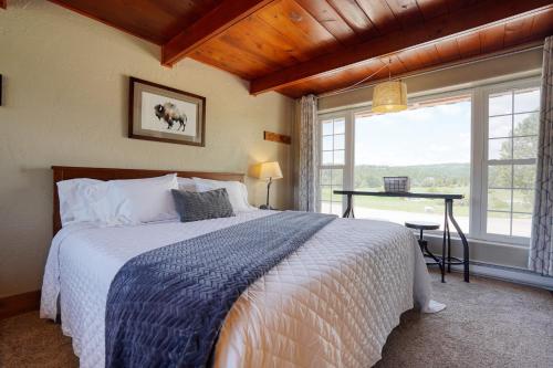 a bedroom with a bed and a large window at Meadow Cabin at Highland Meadows in Hot Springs