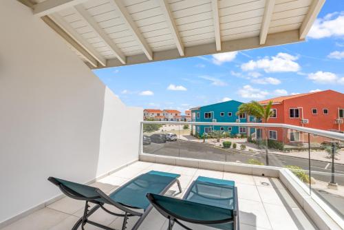 a balcony with chairs and a view of a street at Punta Azul Ocean Resort 6A in Westpunt