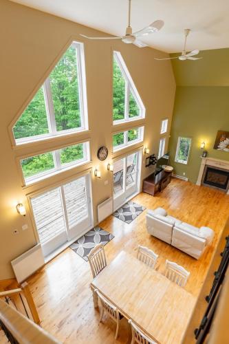 an overhead view of a living room with large windows at Le Havre d'Émélie dogfriendly Lake access in Sainte-Émélie-de-lʼÉnergie