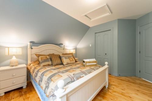 a bedroom with a large white bed in a room at Le Havre d'Émélie dogfriendly Lake access in Sainte-Émélie-de-lʼÉnergie