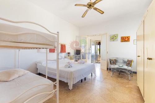 a bedroom with two beds and a ceiling fan at Salentoandmore - Villetta Salento in Marina San Gregorio