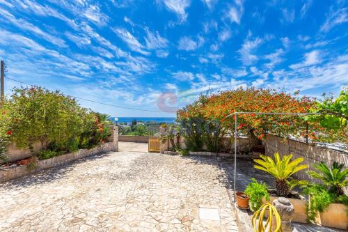 a garden with flowers and plants on a patio at Salentoandmore - Villetta Salento in Marina San Gregorio