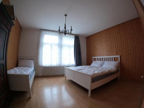 a bedroom with two beds and a window at Harderblick in Interlaken