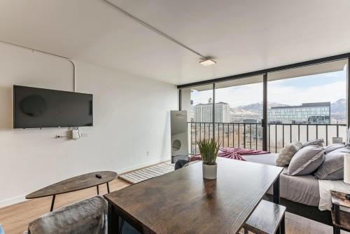 a living room with a couch and a table at Modern Mountain View Downtown Oasis Free Pkg Gym in Salt Lake City