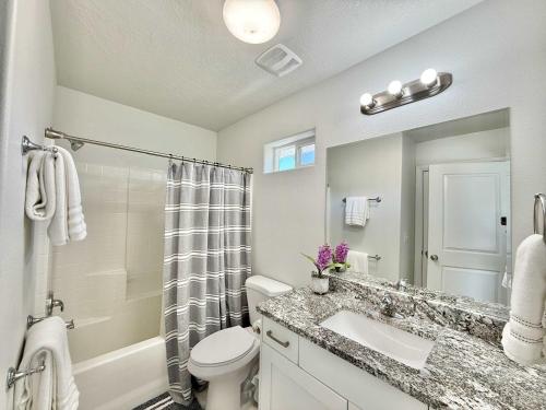 a bathroom with a sink and a toilet and a shower at Townhome in Glendale UT near Zion with hot tub in Glendale