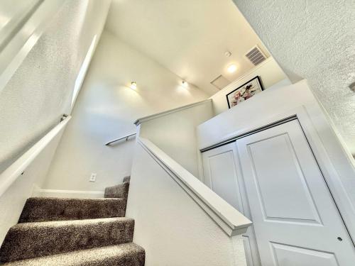 a staircase in a house with a white door at Townhome in Glendale UT near Zion with hot tub in Glendale