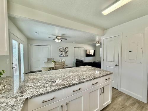 a kitchen with a granite counter top and a living room at Townhome in Glendale UT near Zion with hot tub in Glendale