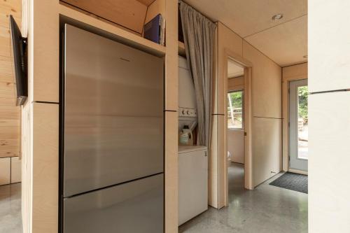 a pivot door in the kitchen of a house at Canadian Classic - Spa - Sauna - Fire - Forest in Val-David