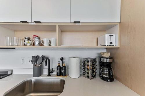 a kitchen counter top with a sink and a counter top at Modern Downtown High Rise Gym Free Pkg in Salt Lake City