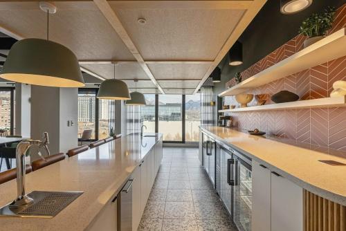 a kitchen with a large counter and a large window at Modern Downtown High Rise Gym Free Pkg in Salt Lake City