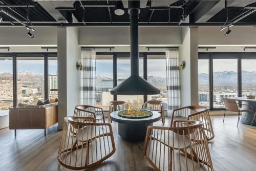 a living room with a table and chairs and mountains at Modern Downtown High Rise Gym Free Pkg in Salt Lake City