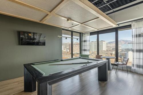 a pool table in a room with a large window at Modern Downtown High Rise Gym Free Pkg in Salt Lake City