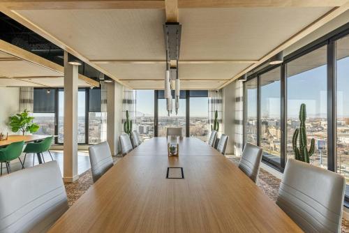 an office with a long table and chairs and windows at Modern Downtown High Rise Gym Free Pkg in Salt Lake City