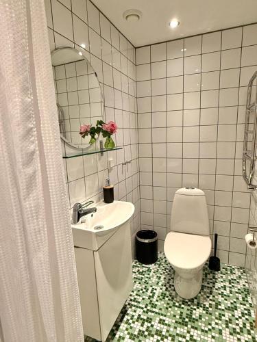 a white bathroom with a sink and a toilet at Rävåkra B&B Österlen in Hammenhög