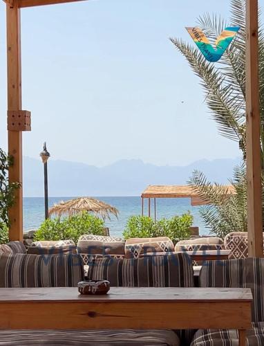 a living room with a couch and a view of the ocean at villa mando camp in Nuweiba