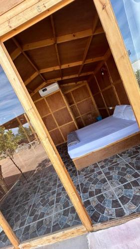 a bed in a room with a wooden frame at villa mando camp in Nuweiba