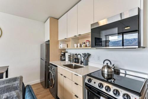 a kitchen with a stove and a sink at The White Mountain View Downtown Studio Apt Free Pkg Gym in Salt Lake City